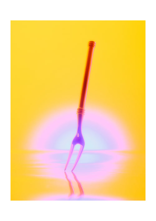 A neon two-pronged fork with a long handle, shown against a bright yellow background with a glowing pink and blue light effect near the base.