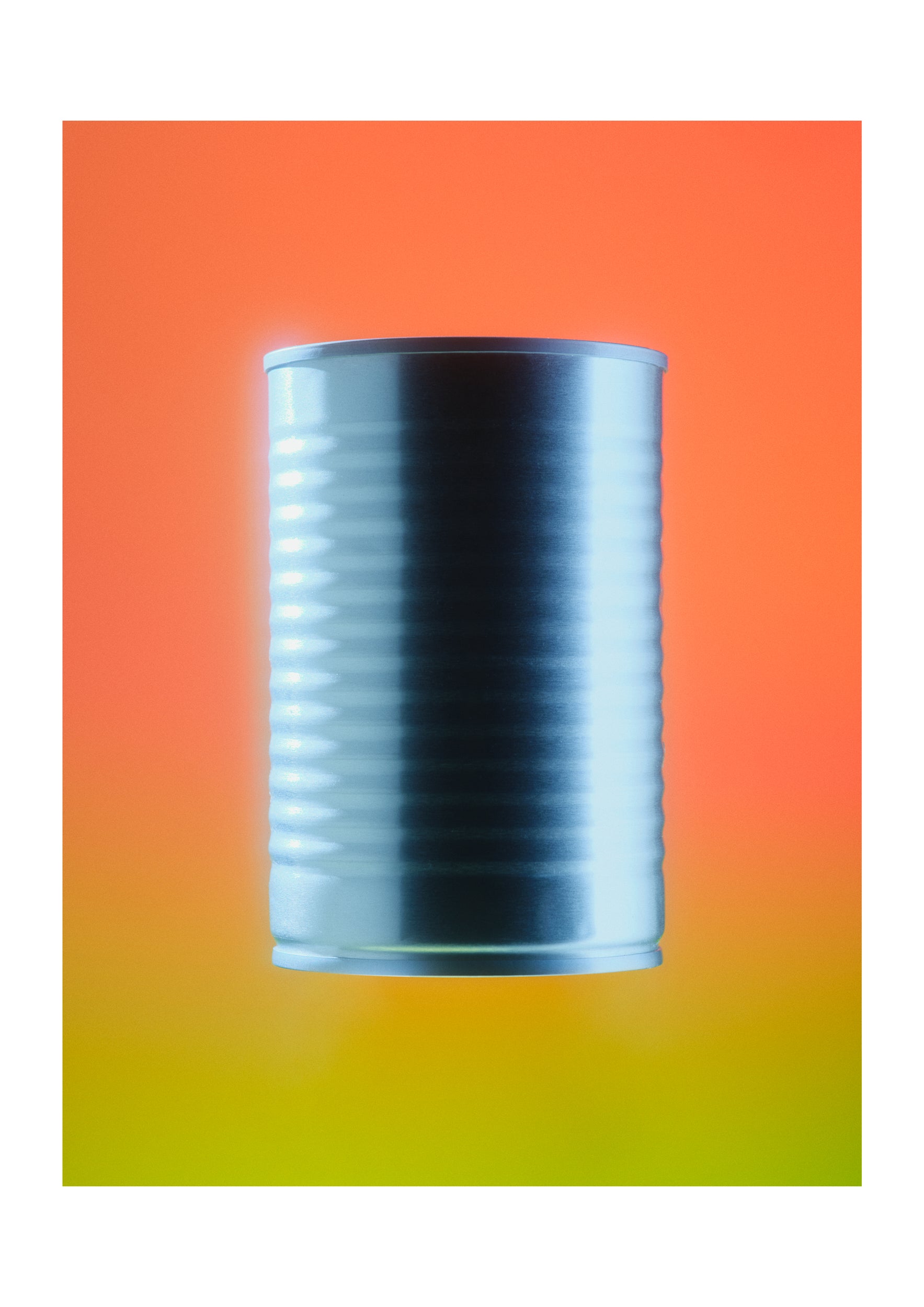 A metallic silver canister centered on a vibrant orange-to-yellow gradient background.