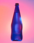 A blue glass water bottle, shown against a vibrant pink and purple gradient background with neon blue and pink lighting.
